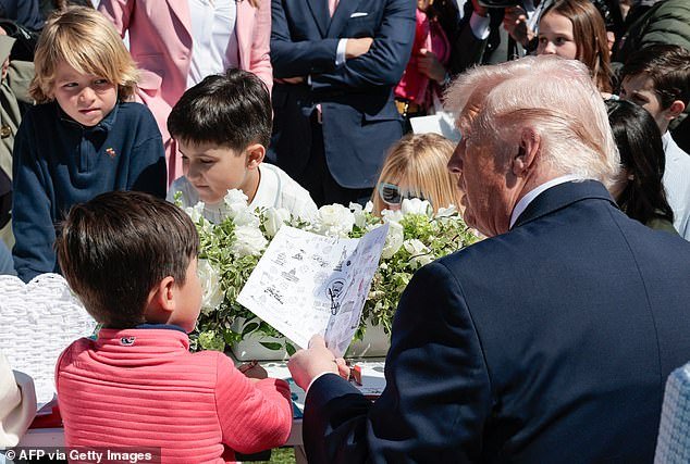 107691989-15710339-President_Donald_Trump_is_photographed_as_he_tells_a_little_boy_-a-50_17755030029.jpeg