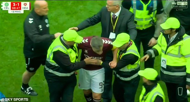 108656549-15824059-Hearts_skipper_Lawrence_Shankland_had_to_be_helped_away_by_stewa-a-40_17789565638.jpeg