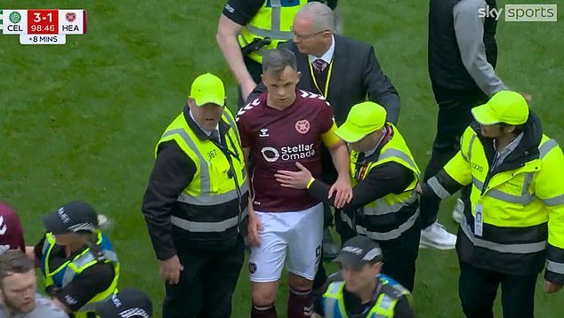 108658581-15824147-Hearts_skipper_Lawrence_Shankland_had_to_be_escorted_off_by_stew-a-2_177896118491.jpeg