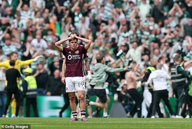 108727793-15838709-Hearts_midfielder_Cammy_Devlin_is_dejected_as_Celtic_fans_invade-a-1_177938884566.jpeg